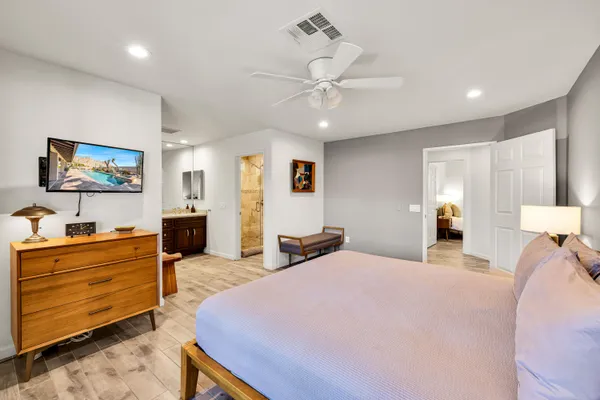 a bedroom with a bed and a chandelier