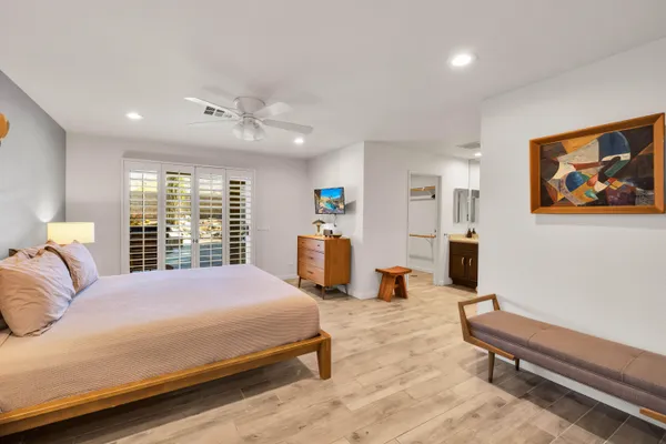 a bedroom with a bed and a large window