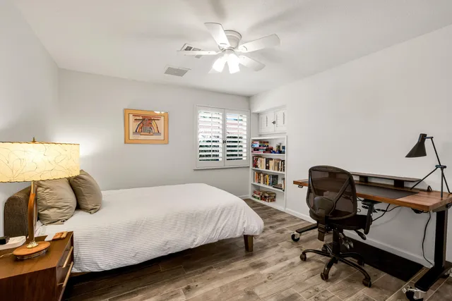 a bedroom with a bed and a chair