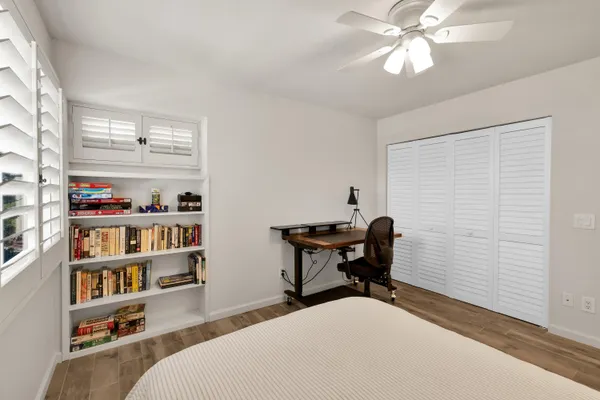 a bedroom with furniture and a book shelf