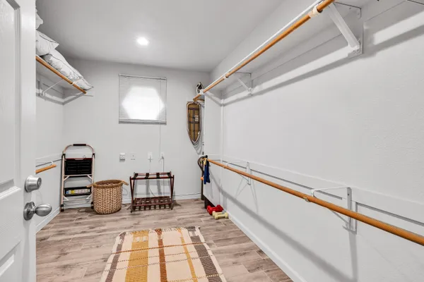 a hallway with a white stove top oven and chairs
