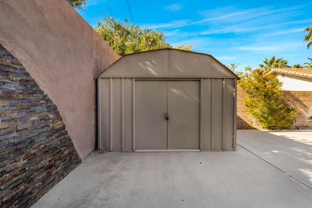 a view of a palm trees front of house