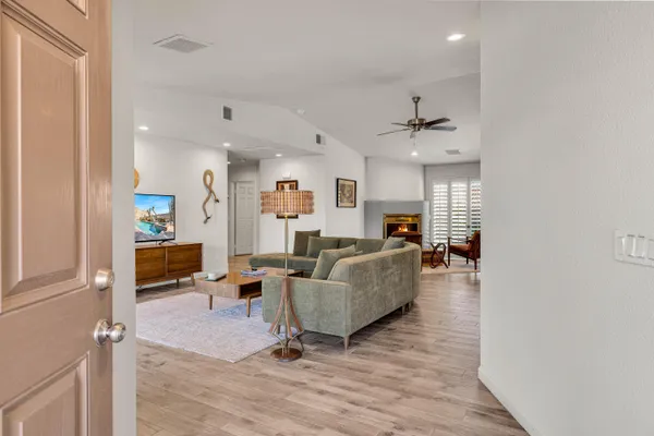 a living room with furniture and a ceiling fan