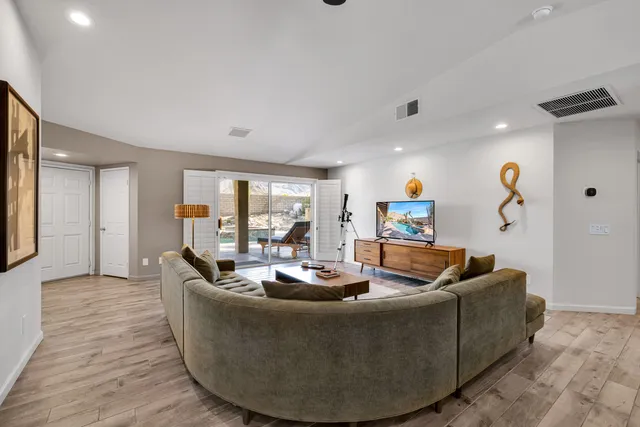 a living room with furniture and a potted plant