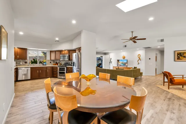 a large kitchen with a table and chairs