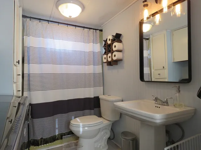 a bathroom with a sink toilet and shower