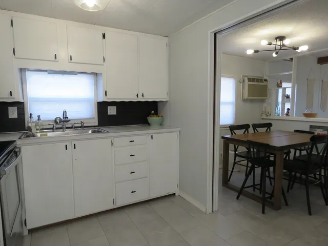 a kitchen with cabinets appliances and a center island