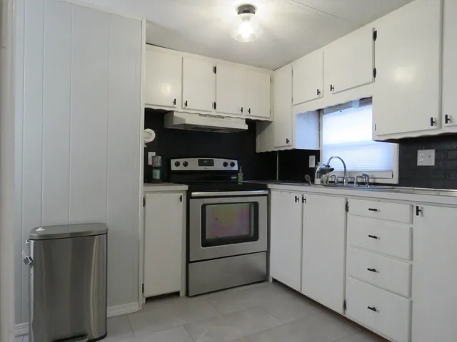 a kitchen with cabinets appliances and a sink