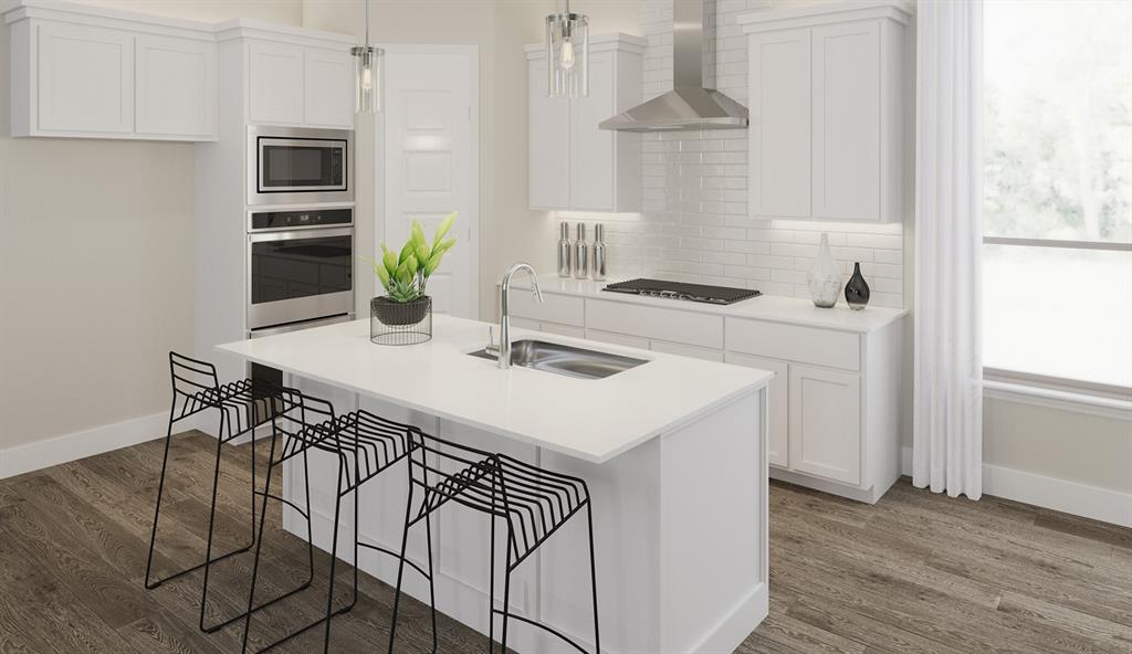 a kitchen with a white cabinets and chairs