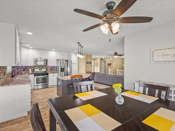 a view of a dining room with furniture and a table
