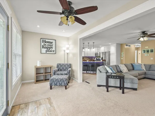 a living room with furniture and a chandelier