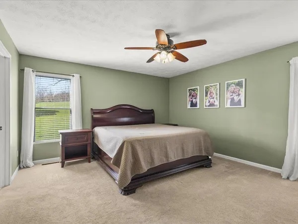 a bedroom with a large bed and a window