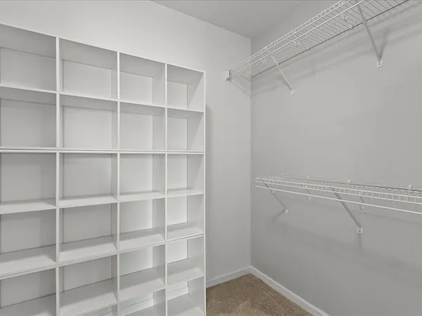 a view of walk in closet with empty racks