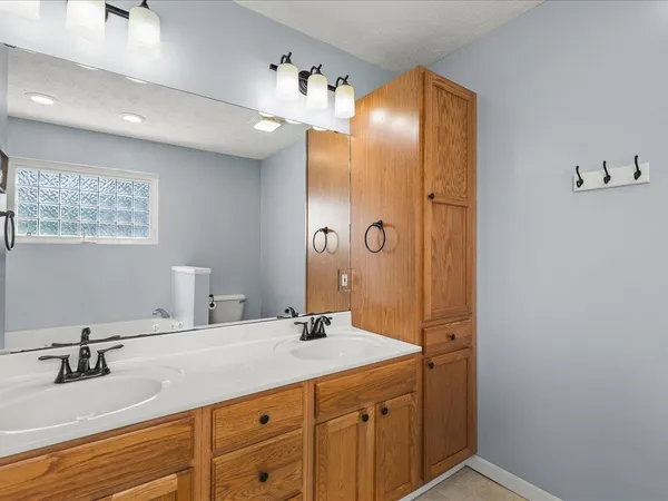 a bathroom with a double vanity sink mirror and double