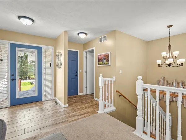 a view of a hallway view with wooden floor and staircase