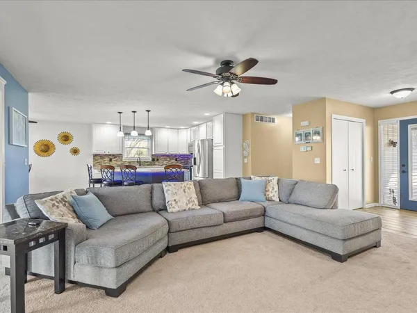 a living room with furniture and a chandelier