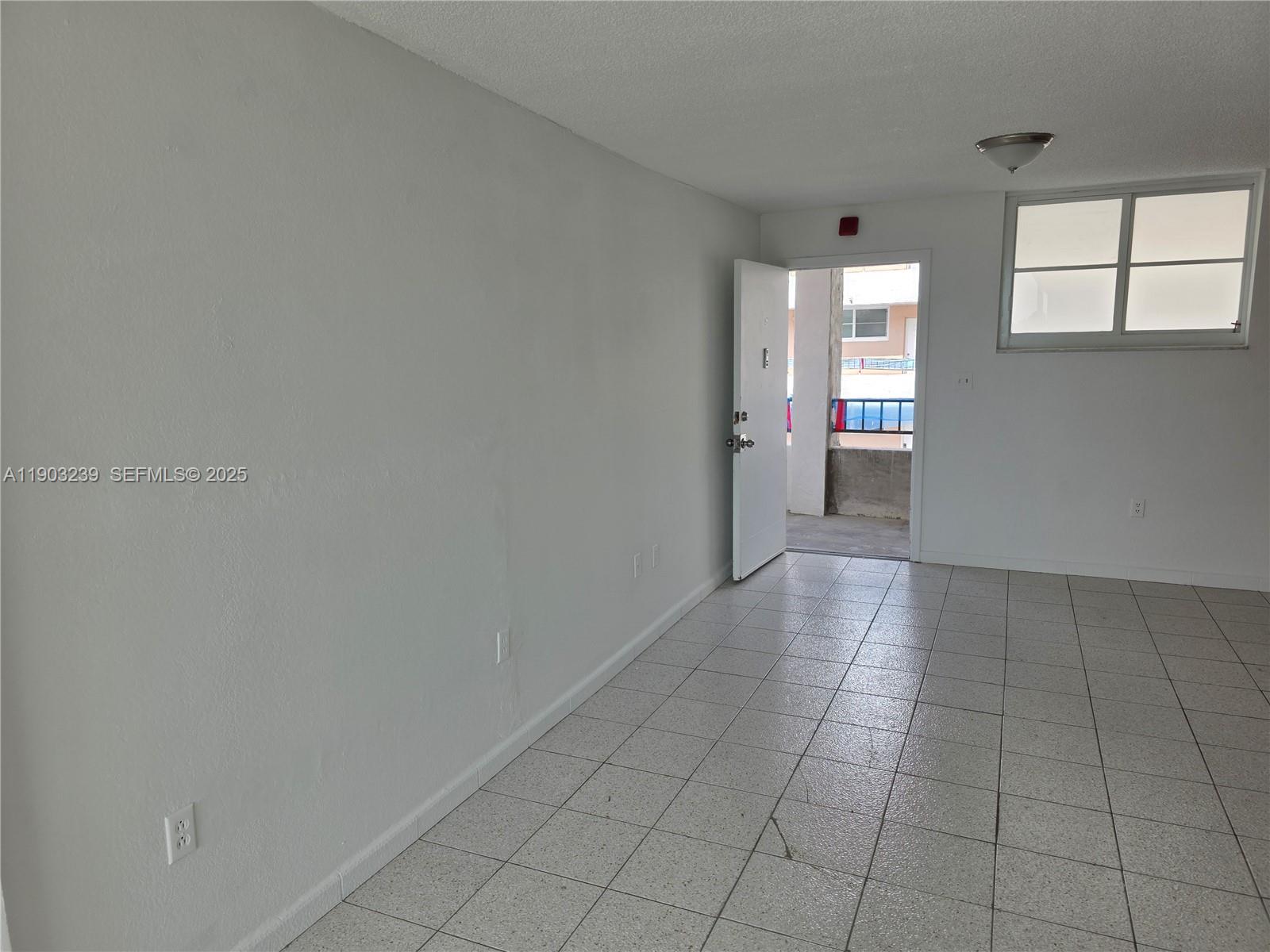 1750 James Avenue, Unit 9C Miami Beach, FL 33139 - Photo 12 of 28 an empty room with windows