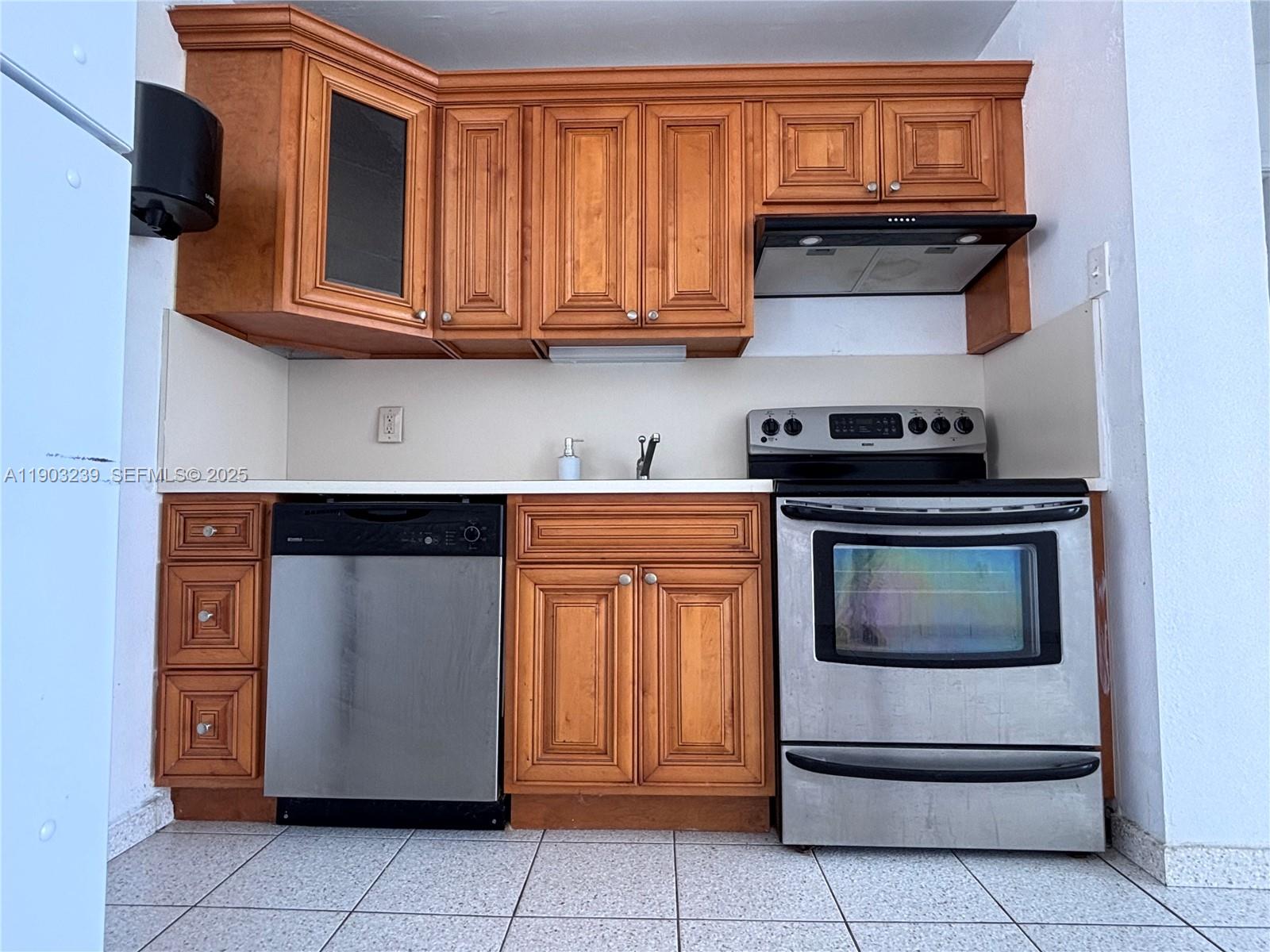 1750 James Avenue, Unit 9C Miami Beach, FL 33139 - Photo 14 of 28 a kitchen with stainless steel appliances granite countertop a stove and a microwave