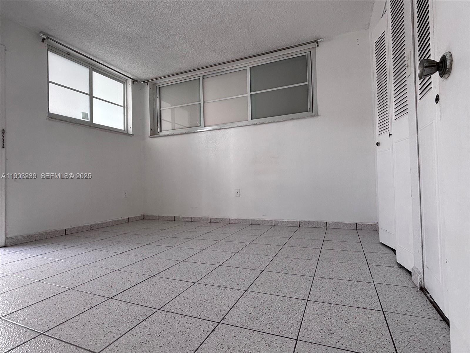1750 James Avenue, Unit 9C Miami Beach, FL 33139 - Photo 17 of 28 an empty room with windows