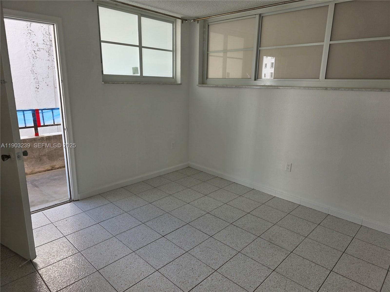 1750 James Avenue, Unit 9C Miami Beach, FL 33139 - Photo 18 of 28 an empty room with windows