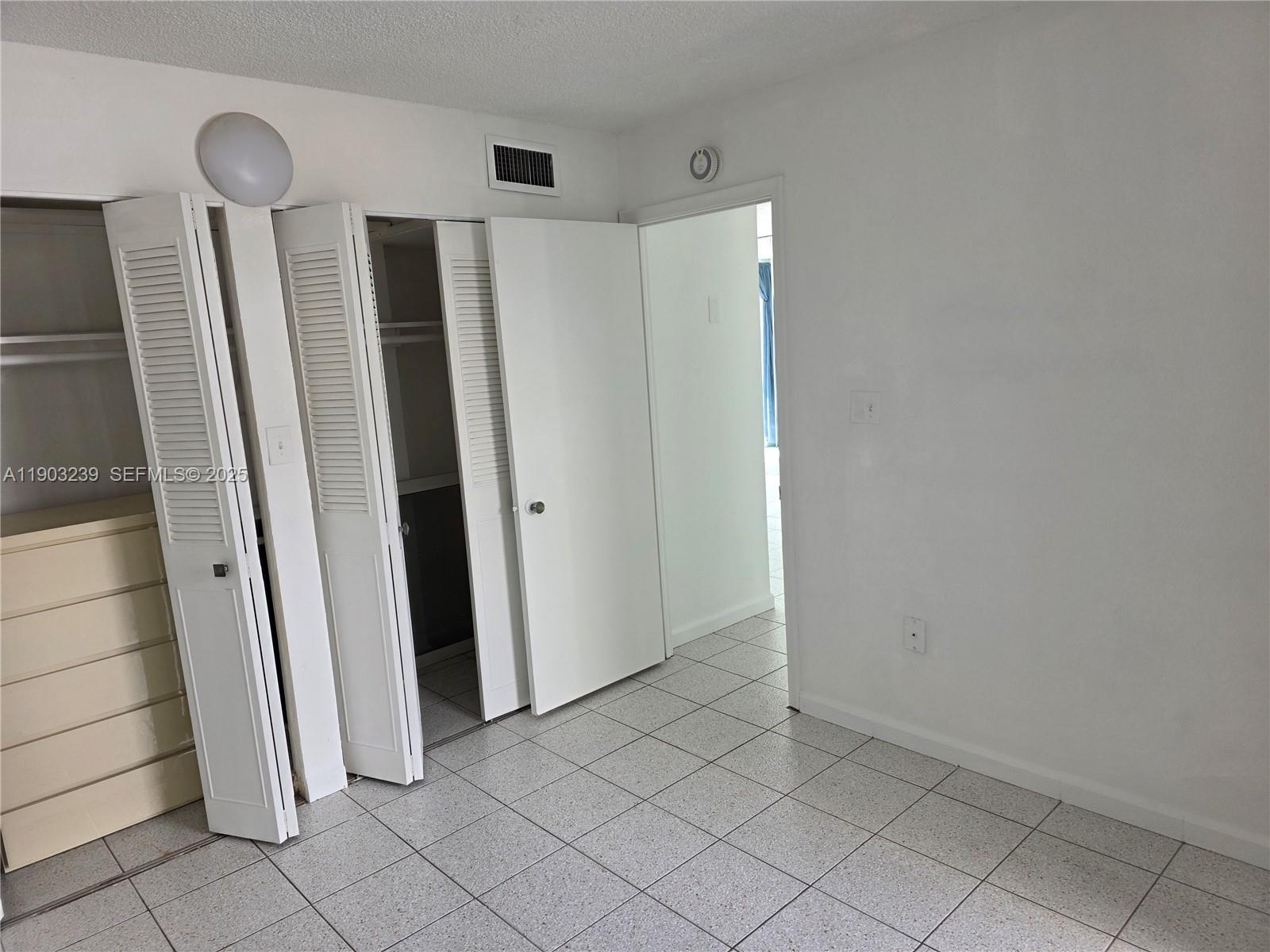 1750 James Avenue, Unit 9C Miami Beach, FL 33139 - Photo 19 of 28 a view of a refrigerator in kitchen and an empty room