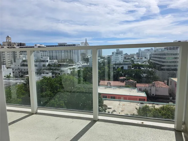 a view of a balcony with floor to ceiling windows and city view
