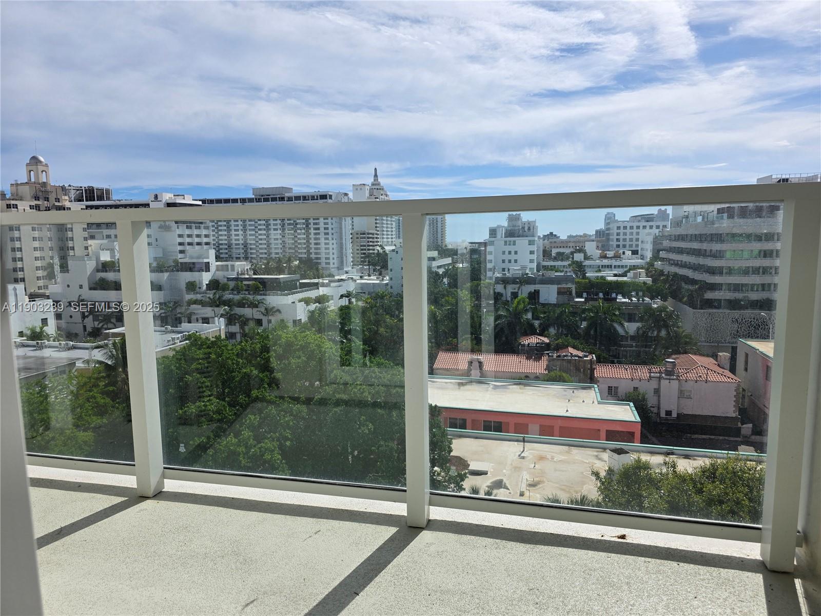 1750 James Avenue, Unit 9C Miami Beach, FL 33139 - Photo 6 of 28 a view of a balcony with floor to ceiling windows and city view