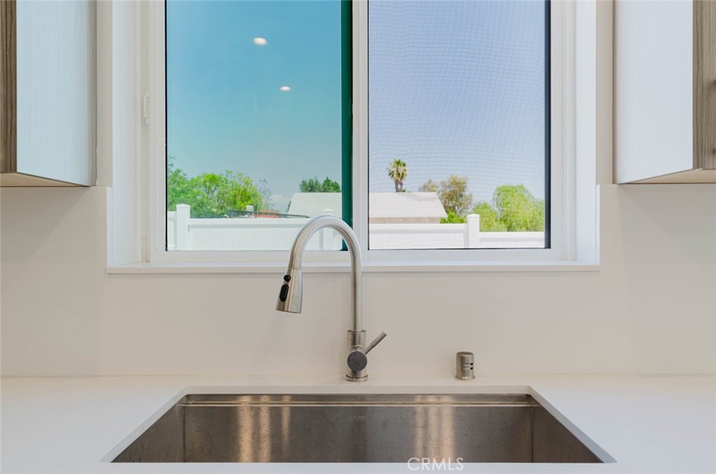17846 Rinaldi Street Granada Hills, CA 91344 - Photo 15 of 34 a kitchen with a sink and a window