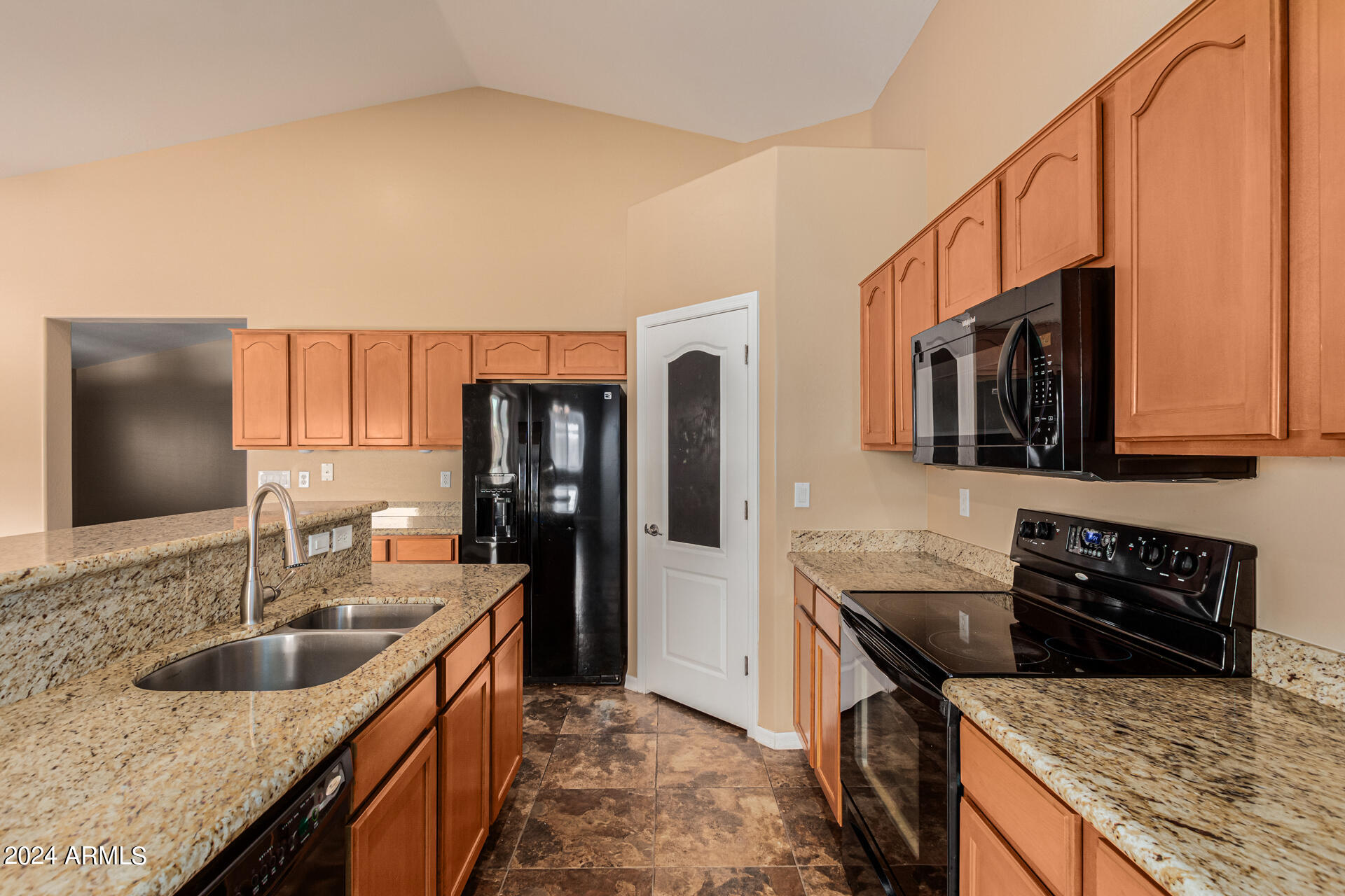 25602 West Ripple Road Buckeye, AZ 85326 - Photo 11 of 38 a kitchen with stainless steel appliances granite countertop a sink stove and refrigerator