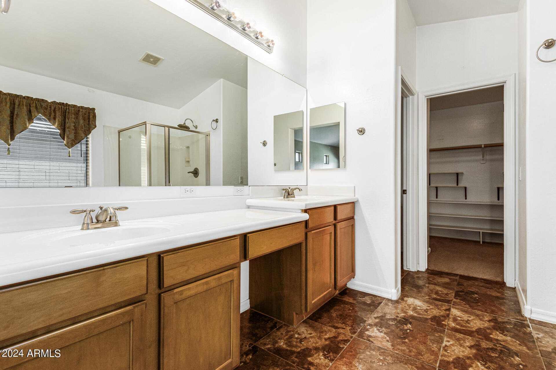 25602 West Ripple Road Buckeye, AZ 85326 - Photo 19 of 38 a bathroom with a sink and a mirror