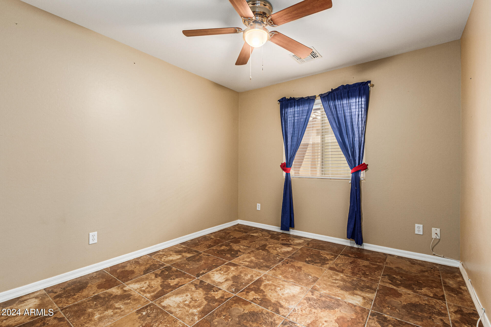 25602 West Ripple Road Buckeye, AZ 85326 - Photo 21 of 38 a view of a room with a ceiling fan and a window