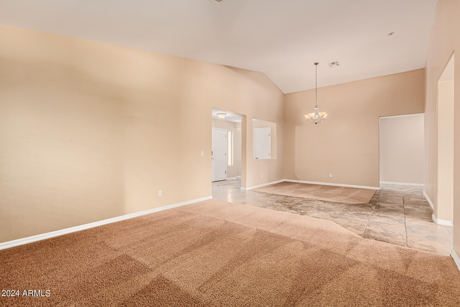 25602 West Ripple Road Buckeye, AZ 85326 - Photo 5 of 38 a view of an empty room with kitchen and a window