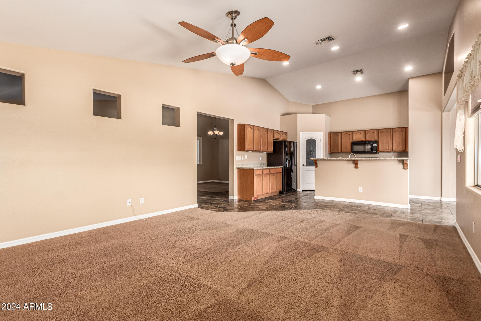 25602 West Ripple Road Buckeye, AZ 85326 - Photo 8 of 38 a view of a kitchen with a sink and a ceiling fan