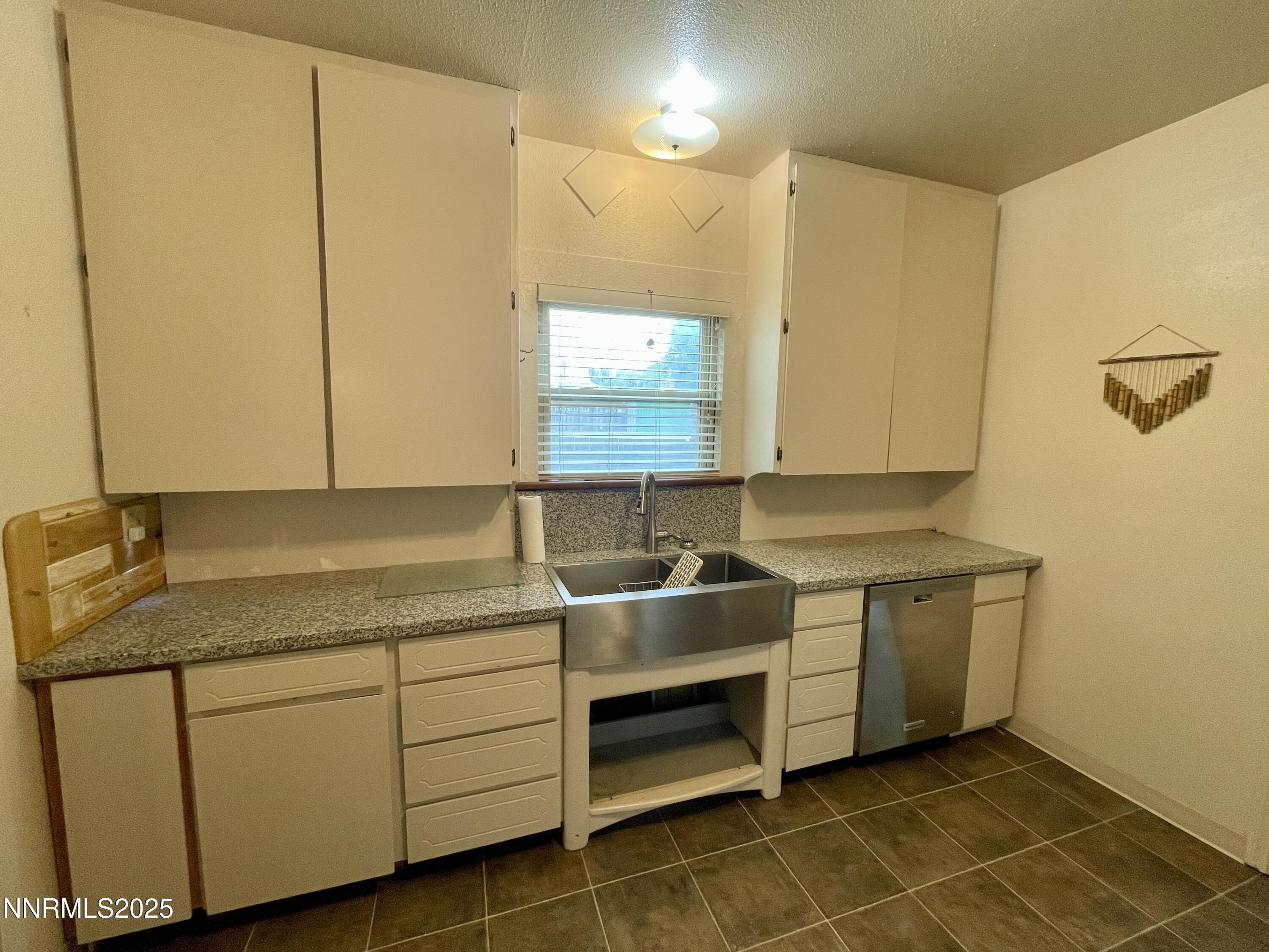 77 Lay Street Winnemucca, NV 89445 - Photo 14 of 28 a room with stainless steel appliances granite countertop a sink and a cabinets