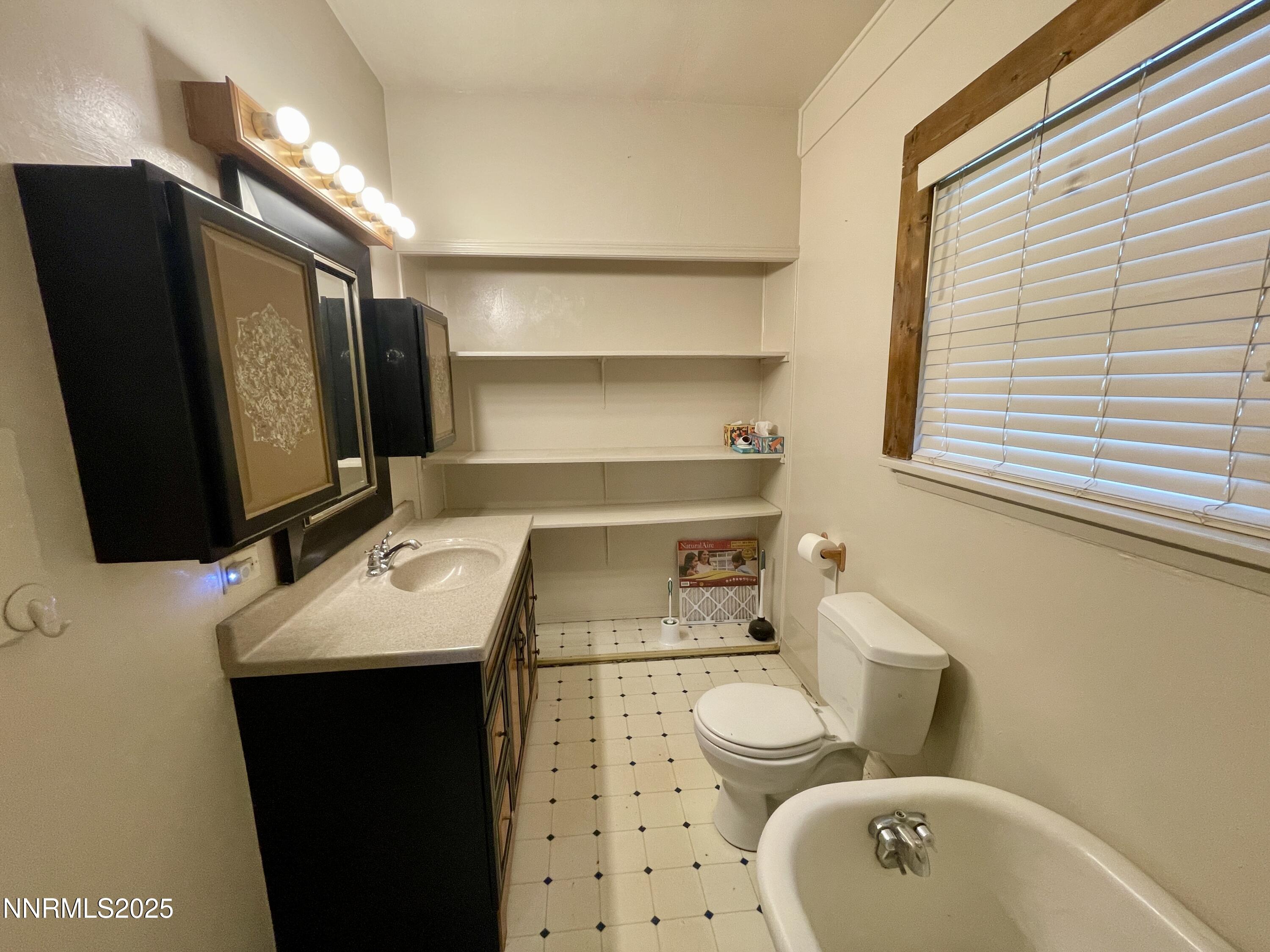 77 Lay Street Winnemucca, NV 89445 - Photo 18 of 28 a bathroom with a sink toilet and mirror
