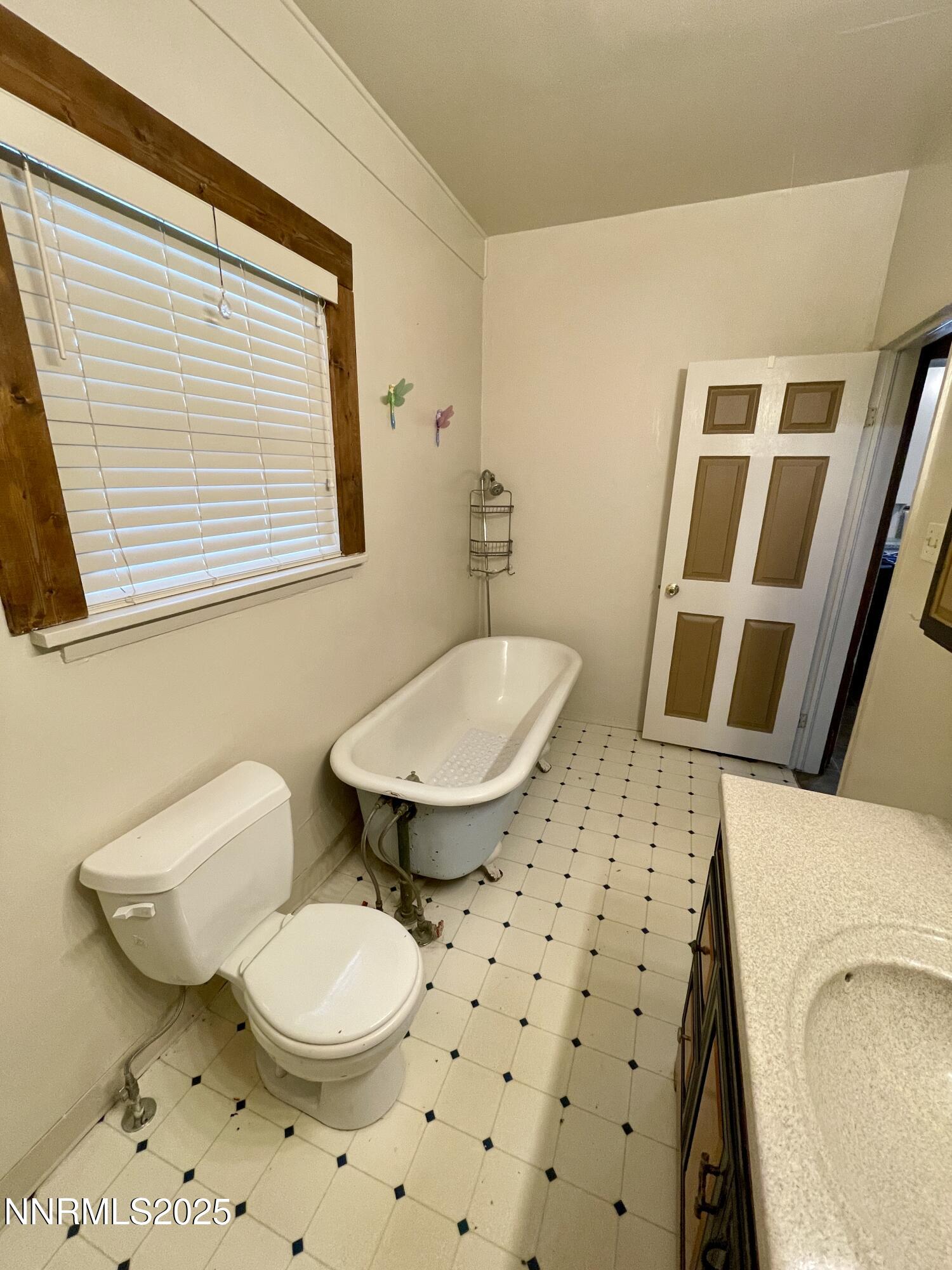 77 Lay Street Winnemucca, NV 89445 - Photo 19 of 28 a bathroom with a toilet a sink and a mirror