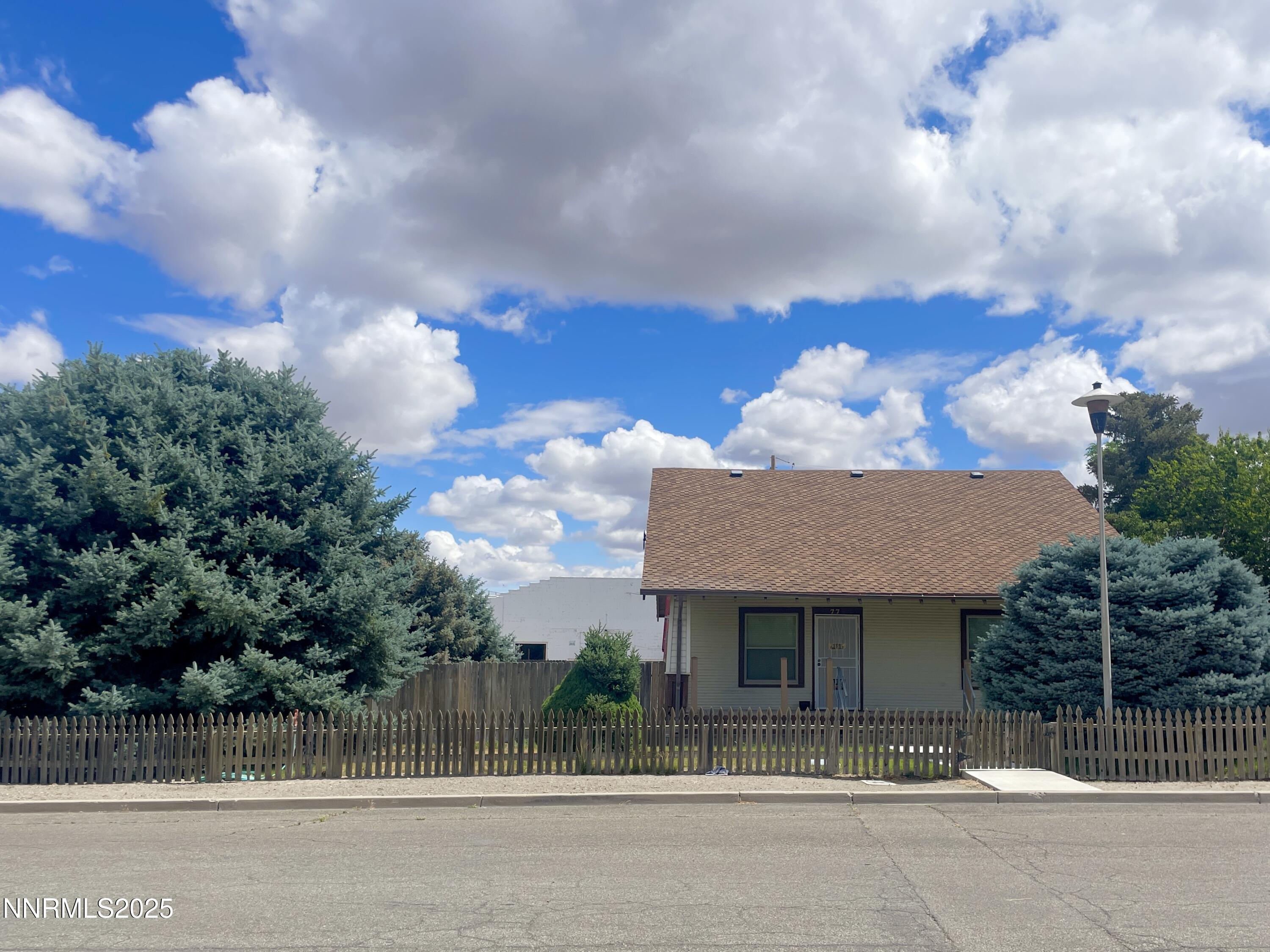 77 Lay Street Winnemucca, NV 89445 - Photo 2 of 28 a view of a house with a iron fence