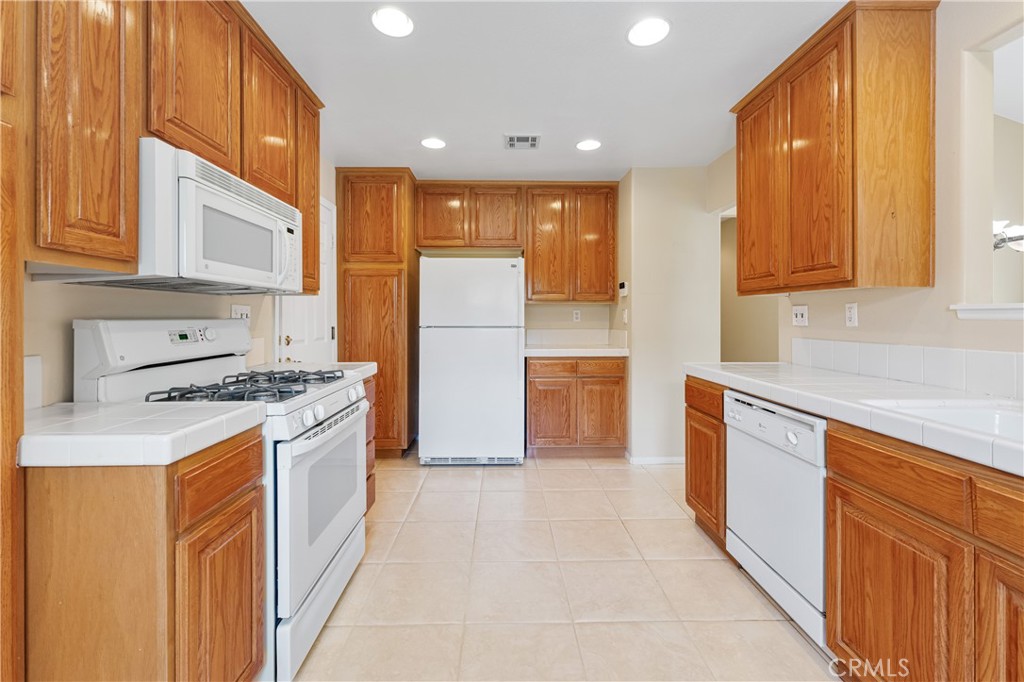 2095 Tulip Avenue Simi Valley, CA 93063 - Photo 12 of 39 a kitchen with stainless steel appliances granite countertop a refrigerator a stove and a sink