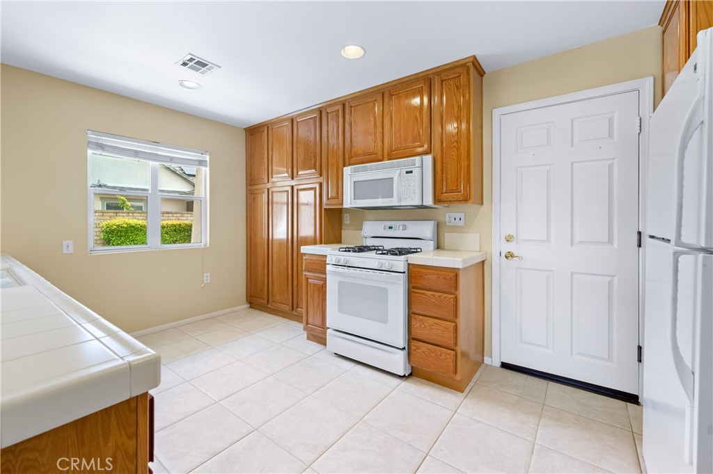 2095 Tulip Avenue Simi Valley, CA 93063 - Photo 14 of 39 a kitchen with a cabinets and appliances