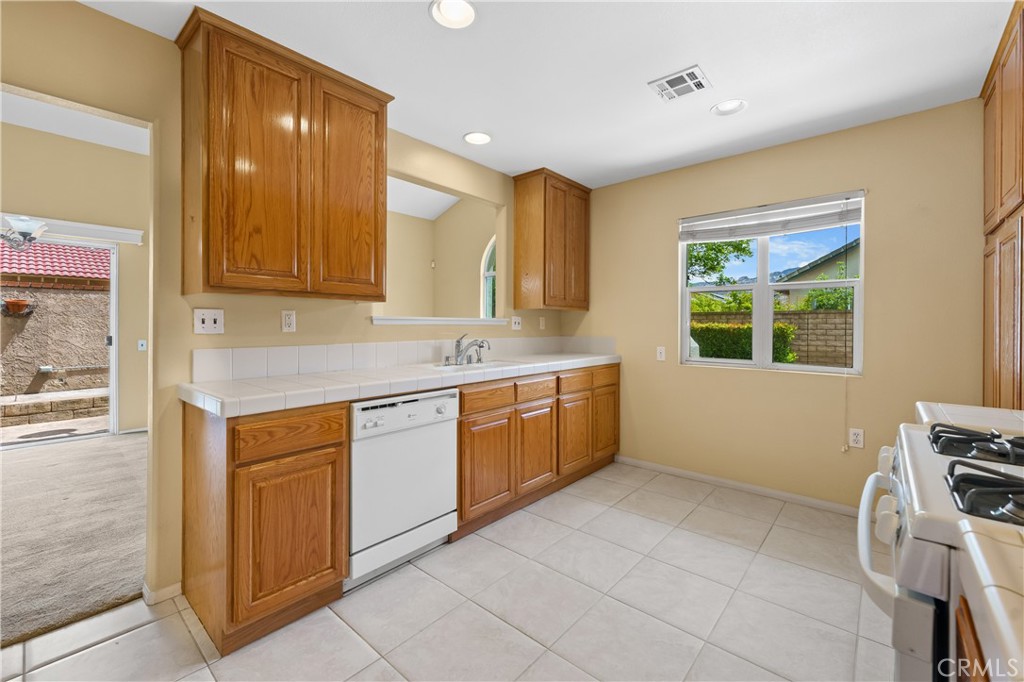 2095 Tulip Avenue Simi Valley, CA 93063 - Photo 15 of 39 a kitchen with a sink cabinets and window