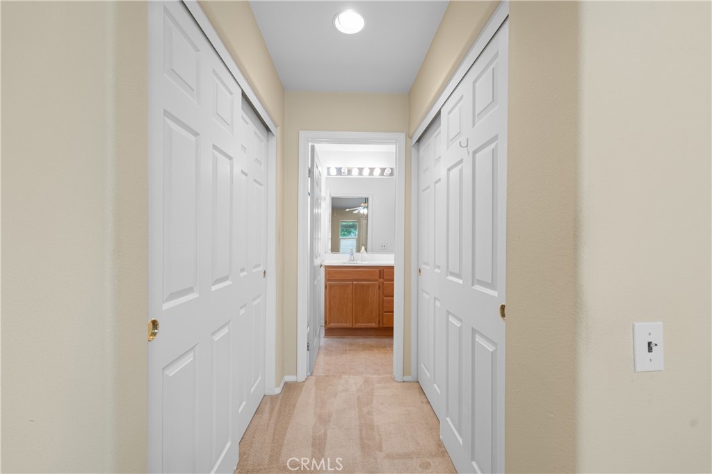2095 Tulip Avenue Simi Valley, CA 93063 - Photo 20 of 39 a view of a hallway with wooden shelves