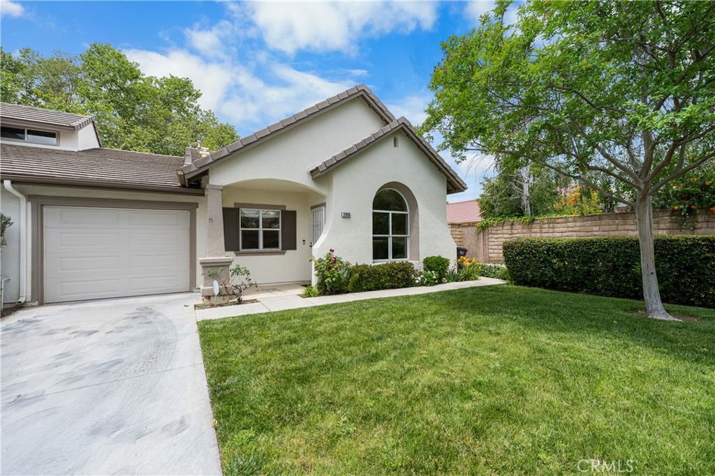 2095 Tulip Avenue Simi Valley, CA 93063 - Photo 2 of 39 a front view of a house with a yard and trees
