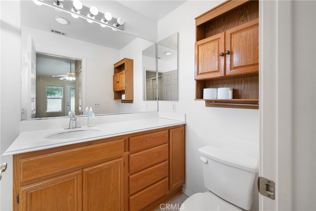 2095 Tulip Avenue Simi Valley, CA 93063 - Photo 21 of 39 a bathroom with a sink a toilet and mirror