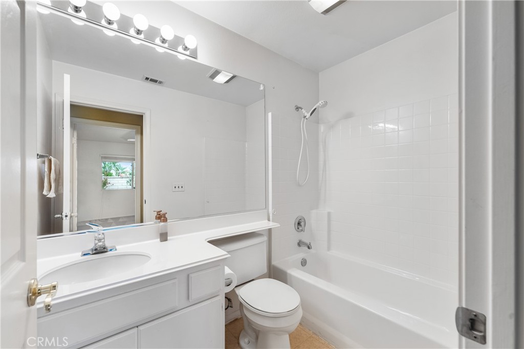 2095 Tulip Avenue Simi Valley, CA 93063 - Photo 24 of 39 a bathroom with a bathtub shower sink mirror vanity and toilet