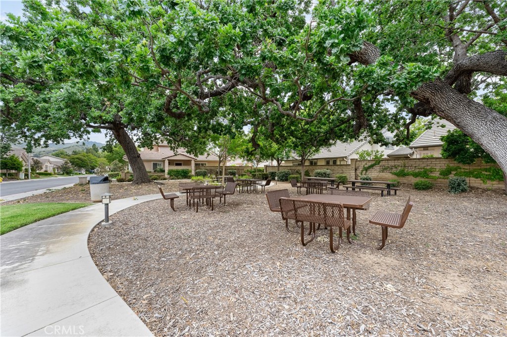 2095 Tulip Avenue Simi Valley, CA 93063 - Photo 36 of 39 a view of a patio with table and chairs potted plants and large tree
