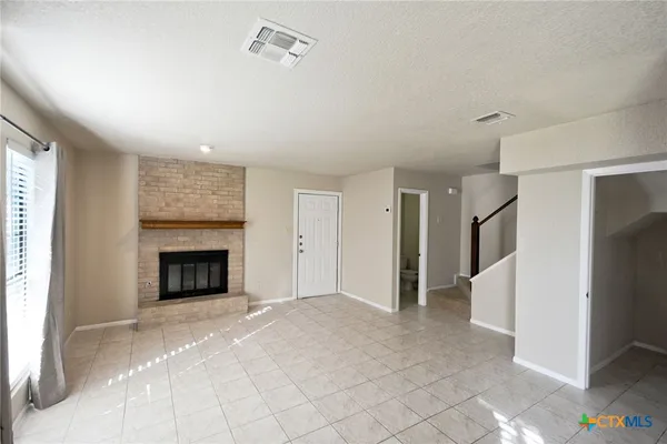 a view of an empty room with a fireplace