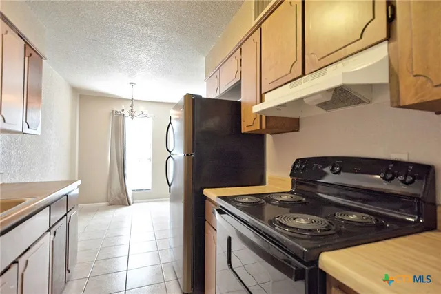 a kitchen with a stove and a refrigerator
