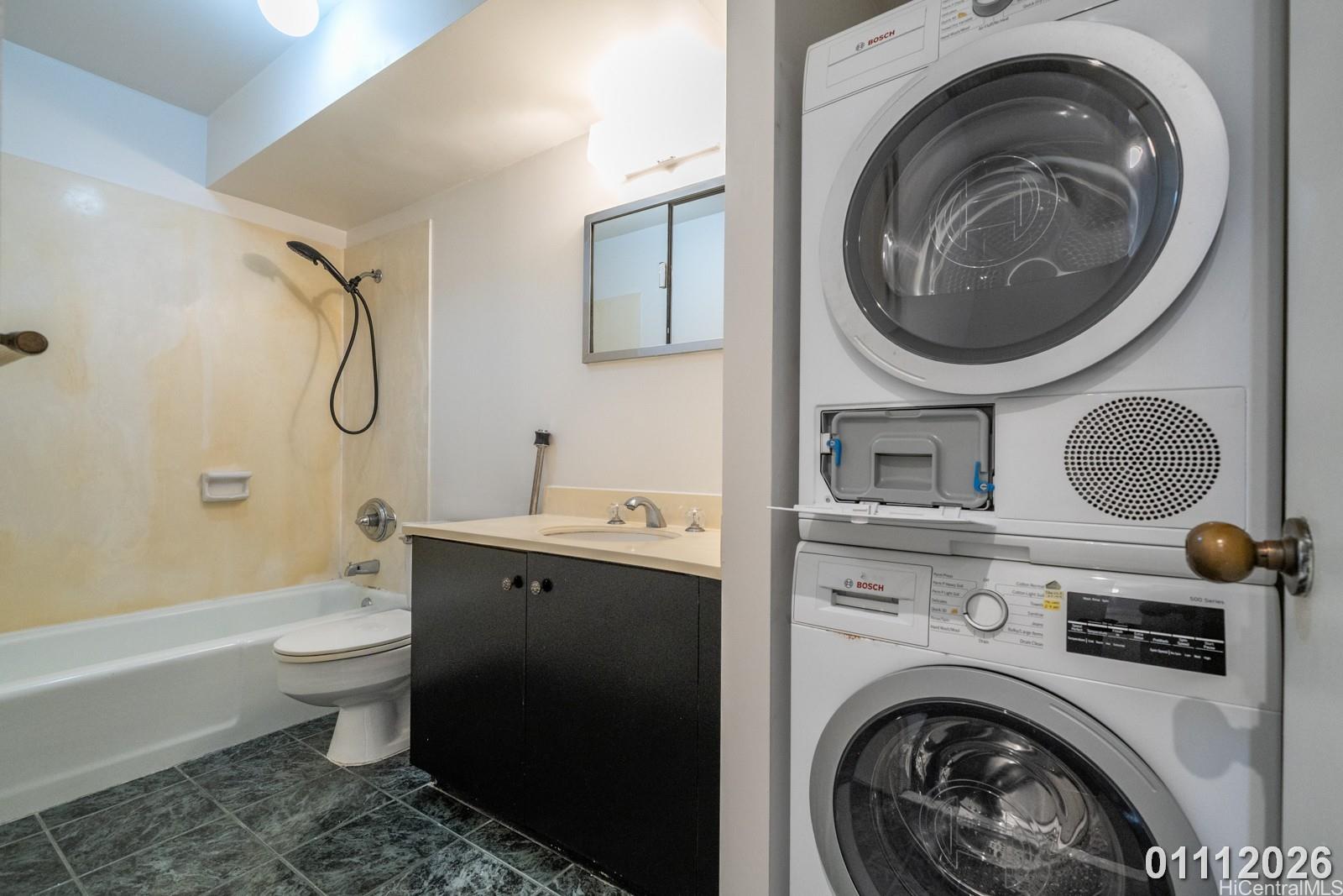 469 Ena Road, Unit 2903 Honolulu, HI 96815 - Photo 13 of 25 a bathroom with a sink mirror vanity and toilet