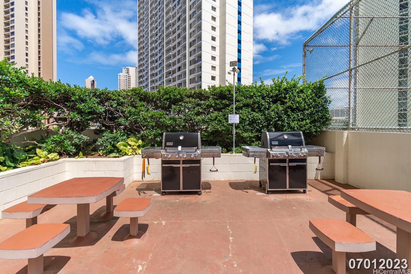 469 Ena Road, Unit 2903 Honolulu, HI 96815 - Photo 20 of 25 a view of backyard with barbeque grill and outdoor seating