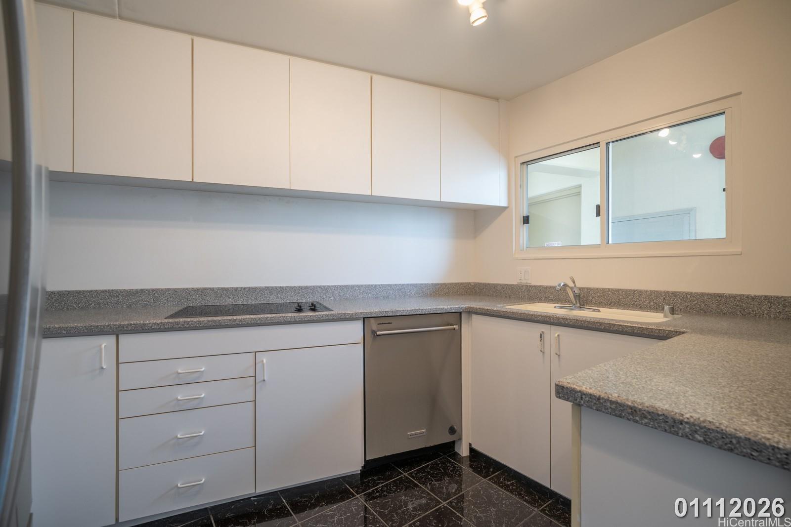 469 Ena Road, Unit 2903 Honolulu, HI 96815 - Photo 8 of 25 a kitchen with a sink and cabinets